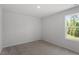Bright bedroom features neutral carpet and a window to the outdoors at 55 Cordoba Dr, Franklinton, NC 27525