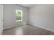 Sun-filled bedroom features wood-look flooring and a bright window at 55 Cordoba Dr, Franklinton, NC 27525