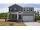 Charming two-story home featuring gray siding, black shutters, and an attached two-car garage at 55 Cordoba Dr, Franklinton, NC 27525