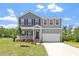 Charming two-story home with a manicured lawn, covered front porch, and attached two-car garage at 55 Cordoba Dr, Franklinton, NC 27525