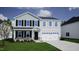 Charming two-story home with a two-car garage, black shutters, and well-manicured lawn at 55 Cordoba Dr, Franklinton, NC 27525