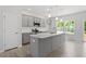Modern kitchen featuring gray cabinets, stainless steel appliances, and a spacious center island at 55 Cordoba Dr, Franklinton, NC 27525