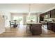 Open concept living area with kitchen island, dining table, and sliding glass doors to the backyard at 55 Cordoba Dr, Franklinton, NC 27525