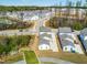 Overhead view of modern homes in a community with green spaces, winding roads, and recreational areas at 5800 Agrinio Way, Raleigh, NC 27603