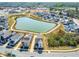 Aerial view showcasing a residential neighborhood with a central pond and community amenities at 5800 Agrinio Way, Raleigh, NC 27603