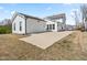 View of the backyard featuring a detached garage and ample parking space on a sunny day at 5800 Agrinio Way, Raleigh, NC 27603
