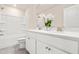 Modern bathroom featuring double sinks, white cabinets, quartz countertop, and a shower-tub combination at 5800 Agrinio Way, Raleigh, NC 27603
