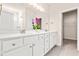 Bathroom features a large double sink vanity with white counter and a door to a walk in closet at 5800 Agrinio Way, Raleigh, NC 27603