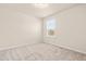 Neutral bedroom featuring soft carpet and a window providing natural light and views at 5800 Agrinio Way, Raleigh, NC 27603