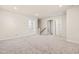 Neutral bonus room space with a view of the entry stairs from the first floor at 5800 Agrinio Way, Raleigh, NC 27603