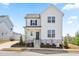 Charming two-story home with a modern farmhouse design and a well-manicured front yard at 5800 Agrinio Way, Raleigh, NC 27603