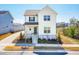 Charming two-story home with a well-manicured lawn and inviting front porch under a clear blue sky at 5800 Agrinio Way, Raleigh, NC 27603