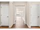 Inviting hallway with hardwood floors and neutral paint, leading to open living spaces at 5800 Agrinio Way, Raleigh, NC 27603