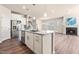 Modern kitchen featuring stainless steel appliances, granite countertops, and a large island with a sink at 5800 Agrinio Way, Raleigh, NC 27603