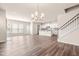 Open-concept living space featuring hardwood floors, natural light, and a staircase at 5800 Agrinio Way, Raleigh, NC 27603