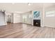 Spacious living room with hardwood floors, fireplace, and lots of natural light at 5800 Agrinio Way, Raleigh, NC 27603