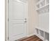 Organized mudroom features a bench, cubbies, hooks, and wood-look flooring for functionality at 5800 Agrinio Way, Raleigh, NC 27603