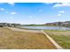 Picturesque view of a community pond with a walking trail, surrounded by well-maintained homes at 5800 Agrinio Way, Raleigh, NC 27603
