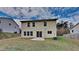 Backyard featuring a patio area, grassy lawn, and a two-story home exterior with light siding at 613 Ashburn Ln, Durham, NC 27703