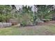 Expansive, partially wooded backyard featuring a wooden fence and mature trees in a peaceful setting at 613 Ashburn Ln, Durham, NC 27703