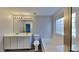 Bright bathroom with double sink vanity, soaking tub, and wood-look floors at 613 Ashburn Ln, Durham, NC 27703