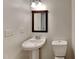 Pedestal sink and toilet in a small bathroom at 613 Ashburn Ln, Durham, NC 27703