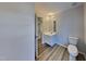 Bright bathroom featuring vinyl floors, toilet, and vanity at 613 Ashburn Ln, Durham, NC 27703