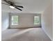 Spacious bedroom with carpet flooring, ceiling fan, neutral walls, and lots of natural light at 613 Ashburn Ln, Durham, NC 27703