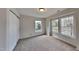 Bedroom with carpet, large windows, and closet at 613 Ashburn Ln, Durham, NC 27703