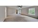 Large bedroom with carpet flooring, ceiling fan, closet, neutral walls, and lots of natural light at 613 Ashburn Ln, Durham, NC 27703