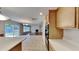 Open kitchen view into the living room with stainless steel appliances and lots of natural light at 613 Ashburn Ln, Durham, NC 27703