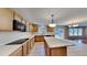 Bright kitchen featuring tile floors, island, cabinets, and stainless steel appliances at 613 Ashburn Ln, Durham, NC 27703