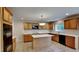 Bright kitchen with island, cabinets, white countertops, and stainless steel appliances at 613 Ashburn Ln, Durham, NC 27703