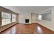 Spacious living room featuring hardwood floors, fireplace, and lots of natural light at 613 Ashburn Ln, Durham, NC 27703