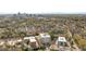 Aerial view of building surrounded by lush trees with city buildings in the distance at 620 Wade Ave # 506, Raleigh, NC 27605