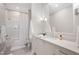 Bright bathroom with herringbone floors, a tub-shower combo, and a large vanity mirror at 620 Wade Ave # 506, Raleigh, NC 27605