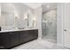 Elegant bathroom with double vanity, marble countertops, tiled floors, and glass enclosed shower at 620 Wade Ave # 506, Raleigh, NC 27605