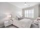 Bright bedroom with a large upholstered headboard, white bedding, and a ceiling fan at 620 Wade Ave # 506, Raleigh, NC 27605