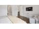 Bright bedroom with hardwood floors, bedside tables, and a tv mounted on the wall at 620 Wade Ave # 506, Raleigh, NC 27605