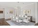 Open-concept dining room featuring modern lighting, seating for ten, and hardwood floors at 620 Wade Ave # 506, Raleigh, NC 27605