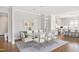 Open concept dining area with a modern glass table, seating for ten, and hardwood floors at 620 Wade Ave # 506, Raleigh, NC 27605