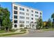 Stunning exterior view of a white brick condo building boasting multiple balconies and beautiful landscaping at 620 Wade Ave # 506, Raleigh, NC 27605