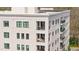 Close-up of a pristine white brick condo with black trimmed windows and multiple balconies at 620 Wade Ave # 506, Raleigh, NC 27605