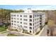 Beautiful exterior view of a white brick building with black framed windows and manicured landscaping at 620 Wade Ave # 506, Raleigh, NC 27605