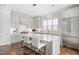 Modern white kitchen featuring an island with seating, stainless steel appliances, and ample counter space at 620 Wade Ave # 506, Raleigh, NC 27605