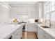 Well-equipped kitchen with white cabinets, stainless steel appliances, large island, and under-cabinet lighting at 620 Wade Ave # 506, Raleigh, NC 27605