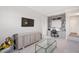 Living room featuring built-in shelving, modern furniture, and a large wall-mounted television at 620 Wade Ave # 506, Raleigh, NC 27605