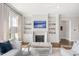 Bright living room with fireplace, built-in shelving, hardwood floors, and comfortable seating at 620 Wade Ave # 506, Raleigh, NC 27605