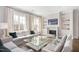 Bright living room with a fireplace, built-in shelves, comfortable seating, and large windows at 620 Wade Ave # 506, Raleigh, NC 27605