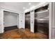 Elegant lobby area with elevators, herringbone floors, and white walls with wood trim at 620 Wade Ave # 506, Raleigh, NC 27605